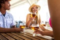 Summer vacation with friends drinking beer and enjoying life at beach bar. Royalty Free Stock Photo