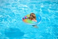 Summer vacation fun. Child swimming and jumping on the waves. Kids having fun at aquapark. Funny kid on inflatable Royalty Free Stock Photo