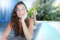 summer vacation girl near swimming pool lying on wood floor