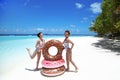 Summer Vacation. Happy free two women with Inflatable donut float mattress. Girls in fashion swimwear  having fun and enjoying Royalty Free Stock Photo