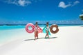 Summer Vacation. Happy free twoSummer Vacation. Happy free two women with donut float mattress. Girls wearing Chiffon Beach Dress Royalty Free Stock Photo