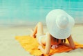 Summer vacation, happy relaxing young woman with straw hat lying on sand on the beach on sea background Royalty Free Stock Photo