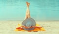 Summer vacation, happy relaxing young woman with straw hat lying on sand on the beach on sea background Royalty Free Stock Photo