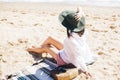 Summer vacation. Happy young boho woman relaxing and enjoying sunny warm day at ocean. Space for text. Stylish hipster girl in hat Royalty Free Stock Photo