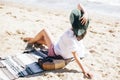 Summer vacation. Happy young boho woman relaxing and enjoying sunny warm day at ocean. Space for text. Stylish hipster girl in hat Royalty Free Stock Photo