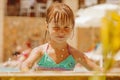 Summer vacation, healthy lifestyle and happy childhood concept. Cute child girl having fun in swimming pool Royalty Free Stock Photo