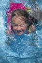 Summer vacation, healthy lifestyle and happy childhood concept. Top view of cute child girl having fun in swimming pool Royalty Free Stock Photo