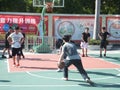 In summer vacation, high school graduates play basketball in the stadium basketball court.