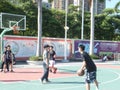 In summer vacation, high school graduates play basketball in the stadium basketball court.