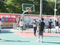 In summer vacation, high school graduates play basketball in the stadium basketball court.