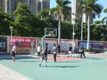 In summer vacation, high school graduates play basketball in the stadium basketball court.