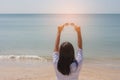 Summer Vacation and Holiday Concept : Woman standing on sand beach. She holding sunglasses in her hand. Royalty Free Stock Photo