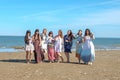 Summer vacation, holidays, travel and people concept - group of smiling young women on beach Royalty Free Stock Photo