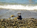 Summer vacation impressions - the children laid on the sand at the water`s edge turrets of stones