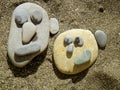 Summer vacation impressions - children laid various stone figurines on the sand