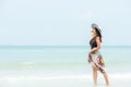 Summer Vacation. Lifestyle woman walking on wave relax and happy on beach tropical outdoor in summer day. Young people luxury and Royalty Free Stock Photo