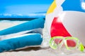 Summer vacation. Mask goggles and color ball on beach background Royalty Free Stock Photo