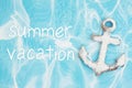 Summer vacation message with weathered anchor on a turquoise paper