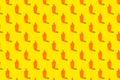 Summer vacation minimal concept. Pattern of orange sunscreen lotion bottles on bright yellow background