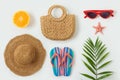 Summer vacation objects. Fashion bag beach hat, flip flops and palm tree leaf on white background. Top view from above Royalty Free Stock Photo