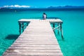Summer vacation photo. Woman sitting alone on the pier