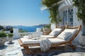 Summer vacation at poolside. Veranda decorated with deck chairs and umbrella with an ocean view Royalty Free Stock Photo