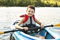 Summer vacation Portrait of happy cute boy kayaking the on river Royalty Free Stock Photo