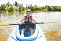 Summer vacation Portrait of happy cute boy kayaking the on river Royalty Free Stock Photo