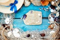 Summer vacation relaxation background theme with seashells, fishing net, hat, rope, stones and weathered wood blue background with Royalty Free Stock Photo