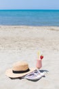 Summer Vacation on the seashore. Glass of fresh cocktail, hat and sunglasses on the beach.