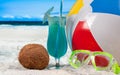 Summer vacation on seaside. Color ball, cocktails and mask on beach Royalty Free Stock Photo