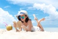 Summer Vacation. Smelling asian women relaxing and reading book on the beach, so happy and luxury in holiday summer, outdoors blue