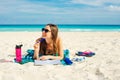 Summer Vacation. Smelling tourist women relaxing and reading book with sunglasses in beach Royalty Free Stock Photo