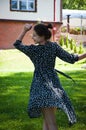 Summer vacation and summertime. Summertime fashion style. Woman in summer dress dancing on the green grass. Romantic girl dance on Royalty Free Stock Photo