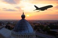 Summer vacation, tourism and travel, airline ticket booking, silhouette of an airplane taking off at sunset on sky background over Royalty Free Stock Photo