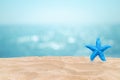 Tropical beautiful seascape view of sand beach with star fish and blurred blue sky with bokeh sunlight in background. Royalty Free Stock Photo