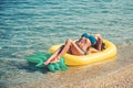 Summer vacation and travel to ocean. Pineapple inflatable mattress, activity and joy. Maldives or Miami beach water Royalty Free Stock Photo