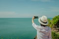 Asian woman standing relax on cliff nearly seashore. Royalty Free Stock Photo