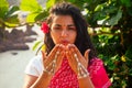 Summer vacation Valentine`s day in India girl sent air kiss and heart shape.beautiful woman wearing indian traditional