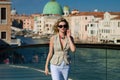 Summer vacation on Venice Italy. Outdoor elegant fashionable woman walking in street of Venice, European city. Woman in