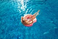 Summer Vacation. Woman in bikini on the inflatable donut mattress in the SPA swimming pool.