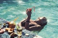 Summer vacation woman drink exotic tropical cocktail on beach with straw, sun tanned body, concept holiday travel. Royalty Free Stock Photo