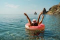 Summer vacation woman in hat floats on an inflatable donut mattress. Happy woman relaxing and enjoying family summer Royalty Free Stock Photo