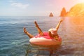 Summer vacation woman in hat floats on an inflatable donut mattress. Happy woman relaxing and enjoying family summer Royalty Free Stock Photo