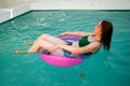 Summer vacation woman in bikini on inflatable donut mattress in swimming pool. girl relaxing sunbathing enjoying travel holidays a Royalty Free Stock Photo