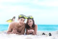 Summer Vacations. Beach travel couple having fun snorkeling. Asian smiling Couple lying and enjoy on summer beach sand with snorke Royalty Free Stock Photo