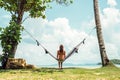 Happy woman in black bikini relaxing in hammock Royalty Free Stock Photo