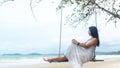 Summer Vacations. Lifestyle women relaxing and enjoying swing outdoors sand beach, Royalty Free Stock Photo