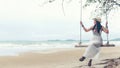 Summer Vacations. Lifestyle women relaxing and enjoying swing outdoors sand beach Royalty Free Stock Photo