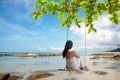 Summer Vacations. Lifestyle women relaxing and enjoying swing on the sand beach, fashion stunning Royalty Free Stock Photo